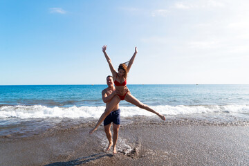 Happy young couple at the sea vacations
