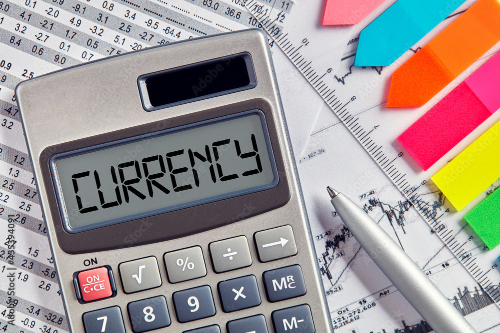 Poster office desktop with calculator displaying the word currency. currency exchange or calculation busine