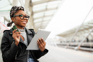 Happy young woman waiting for the train. African woman waiting for a subway train.
