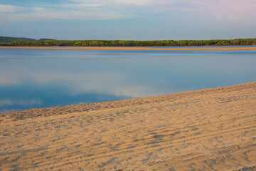 Stunning lake with sandy beach in late afternoon spring in Canada, province of Quebec