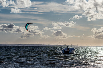 boats and kitesurfers on lake on sea