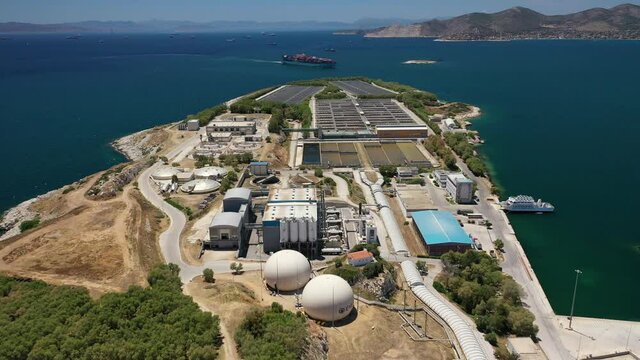 Aerial drone video of latest technology sewage and sludge processing plant in small island of Psitalia or Psyttaleia, Piraeus, Attica, Greece
