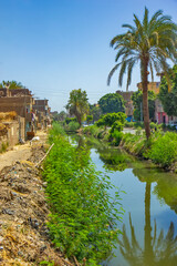 Fototapeta na wymiar Buildings on the Nile canal near Qena, Egypt