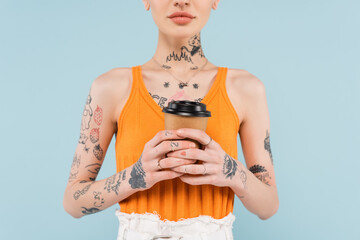 cropped view of tattooed woman holding paper cup isolated on blue - Powered by Adobe