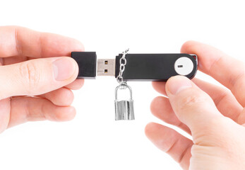 Memory stick with a padlock on a chain in male hands isolated on white