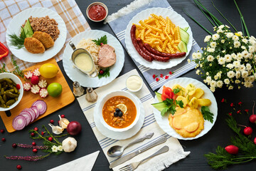 top view of different dishes and other ingredients on wooden table