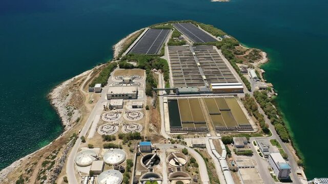 Aerial drone video of latest technology sewage and sludge processing plant in small island of Psitalia or Psyttaleia, Piraeus, Attica, Greece
