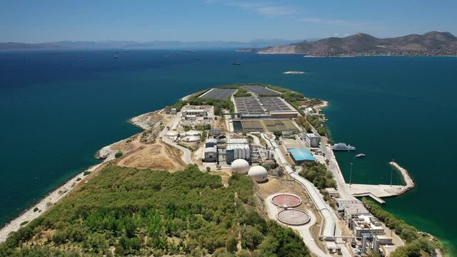 Aerial drone video of latest technology sewage and sludge processing plant in small island of Psitalia or Psyttaleia, Piraeus, Attica, Greece