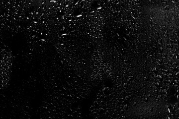water drops on black background. abstract dew water droplets on a window glass for photo overlay effect or giving fresh effect on beverages mockup.