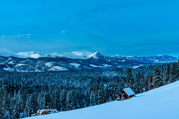 small wood cottage, mountains in winter
