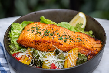 Grilled salmon fish with lemon and vegetables mix