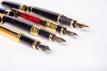 Fountain pen, four beautiful fountain pens in detail on white background, selective focus.