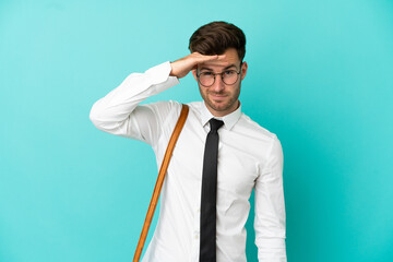 Business man over isolated background looking far away with hand to look something