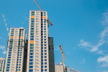 Fototapeta na wymiar Modern apartment building with crane on construction site