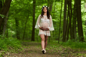 Beautiful latino pregnant woman in the forest