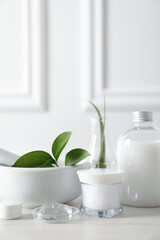 Natural ingredients for cosmetic products and laboratory glassware on white table