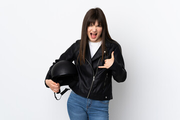 Woman holding a motorcycle helmet isolated on white background making phone gesture