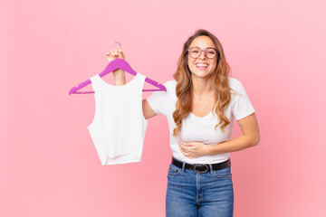 pretty woman laughing out loud at some hilarious joke and choosing clothes