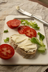 Sandwiches with cream cheese and tomatoes on the white board