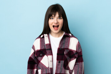 Teenager Ukrainian girl isolated on blue background with surprise facial expression