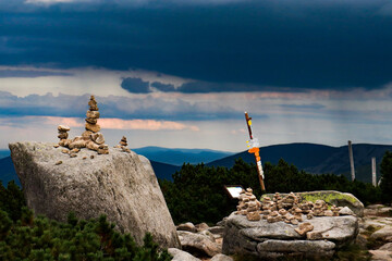 mountain landscape in cloudy day, tower of rocks, marking hiking trail on wood