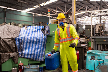 Factory male worker wear safety uniform and safety gas mask holding chemical tank at the industry...