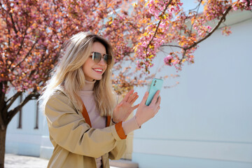 Young woman taking selfie on city street - Powered by Adobe