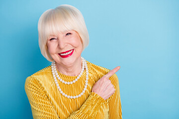 Photo of positive cute short hairdo old lady point empty space wear blouse necklace isolated on...