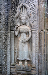 Та Prohm is the temple, it rains in the rainy season.The preserved symbiosis of stone and wood allows us to see Ta Prohm in this form.Bas-relief.(Cambodia, 04.10. 2019).