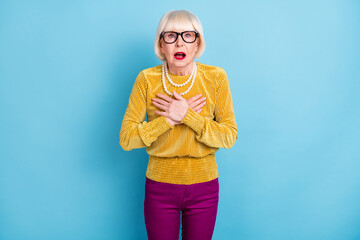 Photo of impressed short hairdo mature lady wear blouse eyewear isolated on blue color background