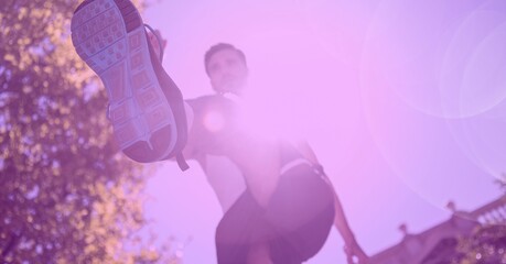 Composition of man running with glowing light and pink tint