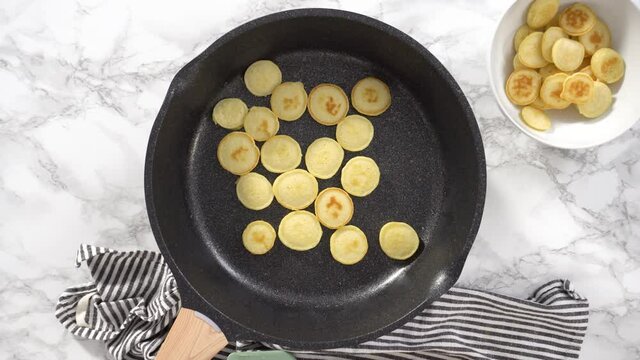 Flat lay. Step by step. Frying mini pancake cereal in a nonstick frying pan.