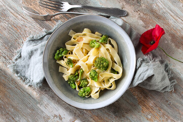 flat lay plate of pasta with romanesco cauliflower on wooden table