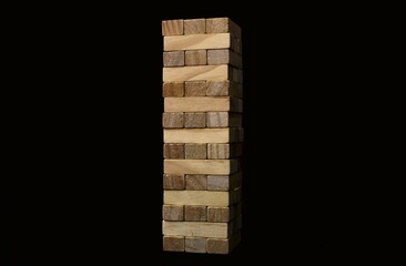 A game of Jenga on a black background. Wooden figurines