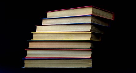 Colorful books are stacked in a stack in the form of a ladder. Ladder of Knowledge