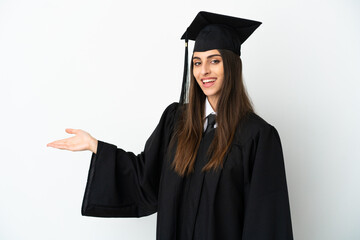 Young university graduate isolated on white background extending hands to the side for inviting to...