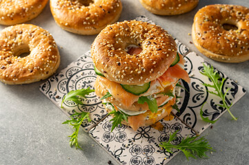 Fresh healthy sandwiches with seeded bagel, mayo, salmon, egg, cucumber and rocket