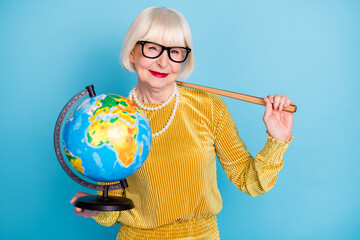 Photo of cheerful short hairdo aged lady hold stick globe wear eyewear blouse isolated on blue color background