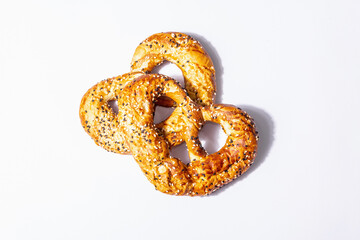 Oktoberfest concept - pretzels isolated on a white background. A trendy hard light, dark shadow