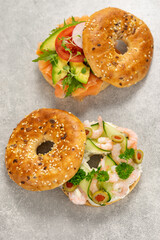 Fresh healthy sandwiches with seeded bagel, sea food and salad