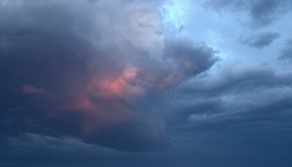 Blue heavy rain clouds at sunset. Blue and red colors of the sky