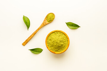 Henna powder in wooden bowl with green leaves. Herbal natural hair dye