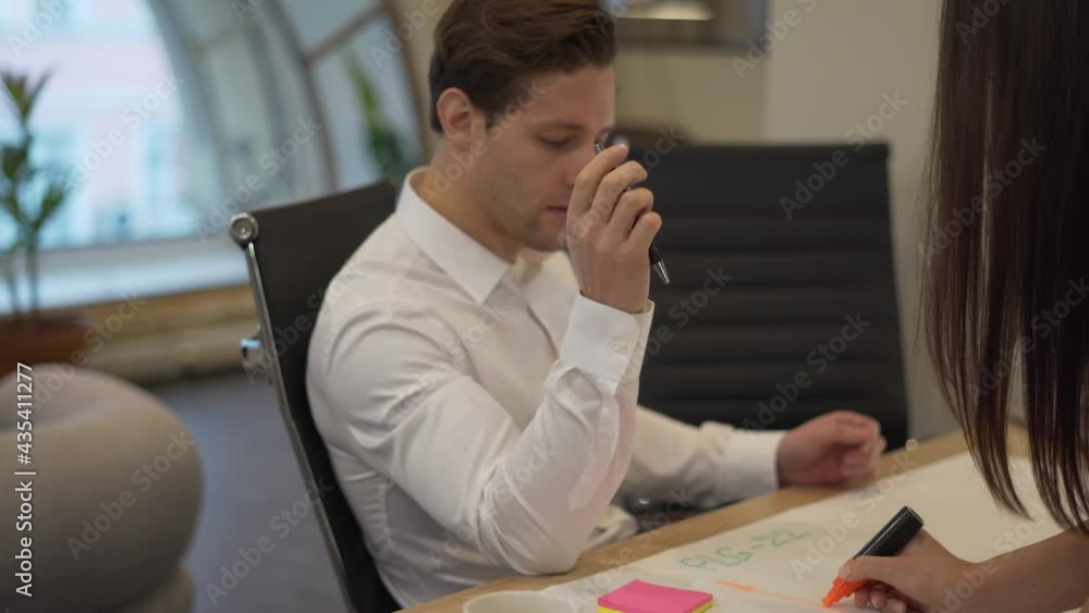 Poster group of caucasian developers analyzing blueprint sketches during corporate brainstorming in office,