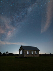 Fototapeta na wymiar Beautiful night sky over little old chapel buildings.