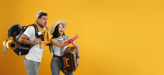 Emotional tourists with backpack and suitcase on yellow background