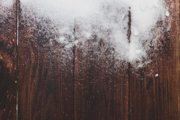 Snowy winter background of real snow on brown boards. Copy space