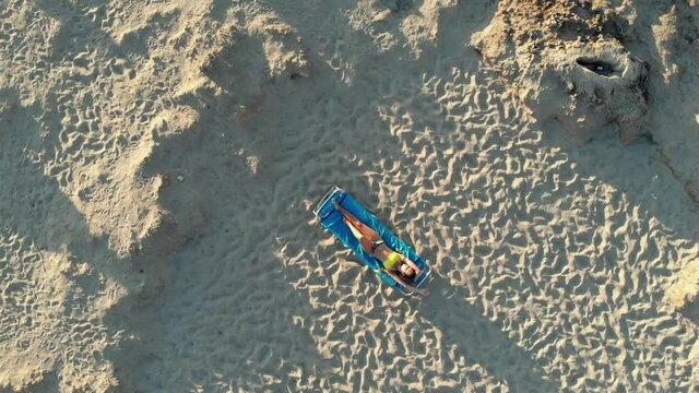Girl lying on a couch with a view from above