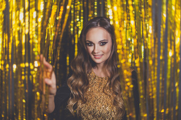 Beautiful woman celebrity with makeup on golden bokeh background