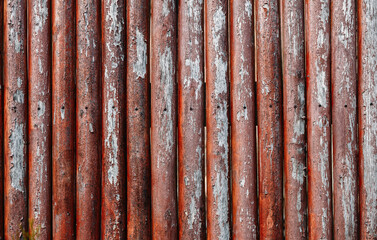 Background from red old smooth boards. Old fence with cracked paint.