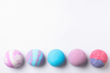Colorful bath bombs on white background, flat lay. Space for text